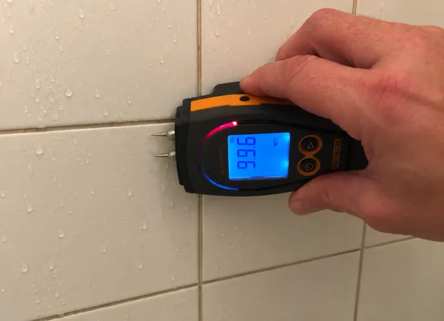 Moisture detected behind bathroom shower tile